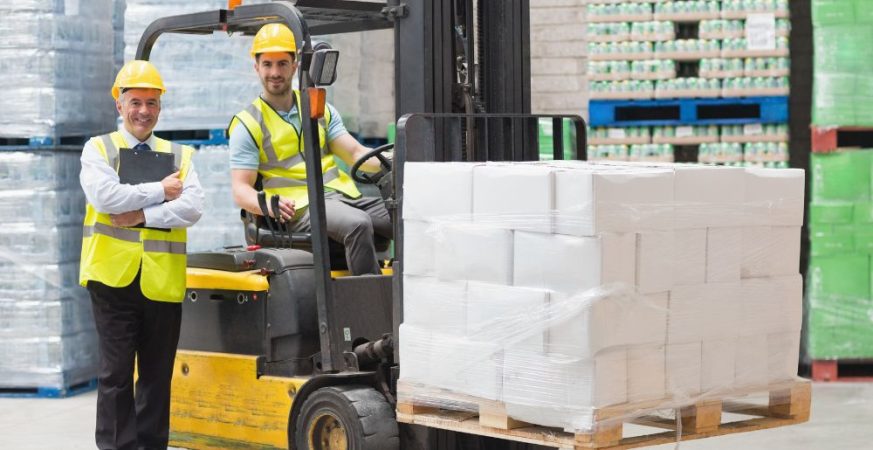 Copie e cole: Operador de empilhadeira e supervisor de segurança realizando checklist de conformidade com a norma NR-11 em centro de distribuição.